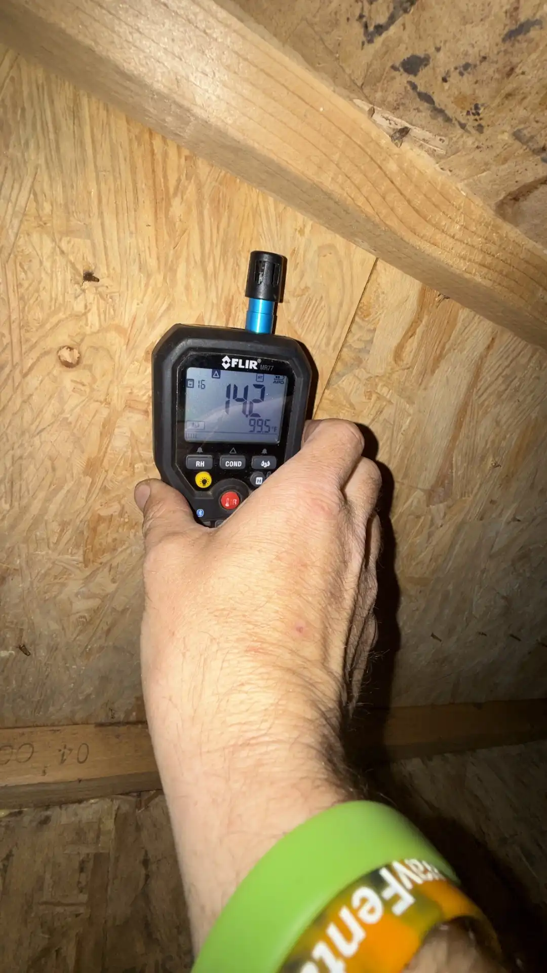 Moisture meter reading 14.2% on attic wood